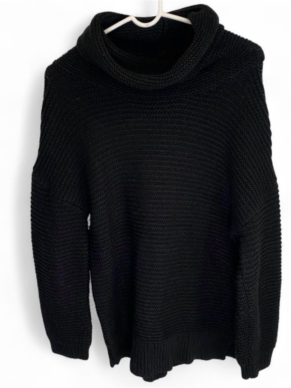 Black chunky knit turtleneck sweater with ribbed texture